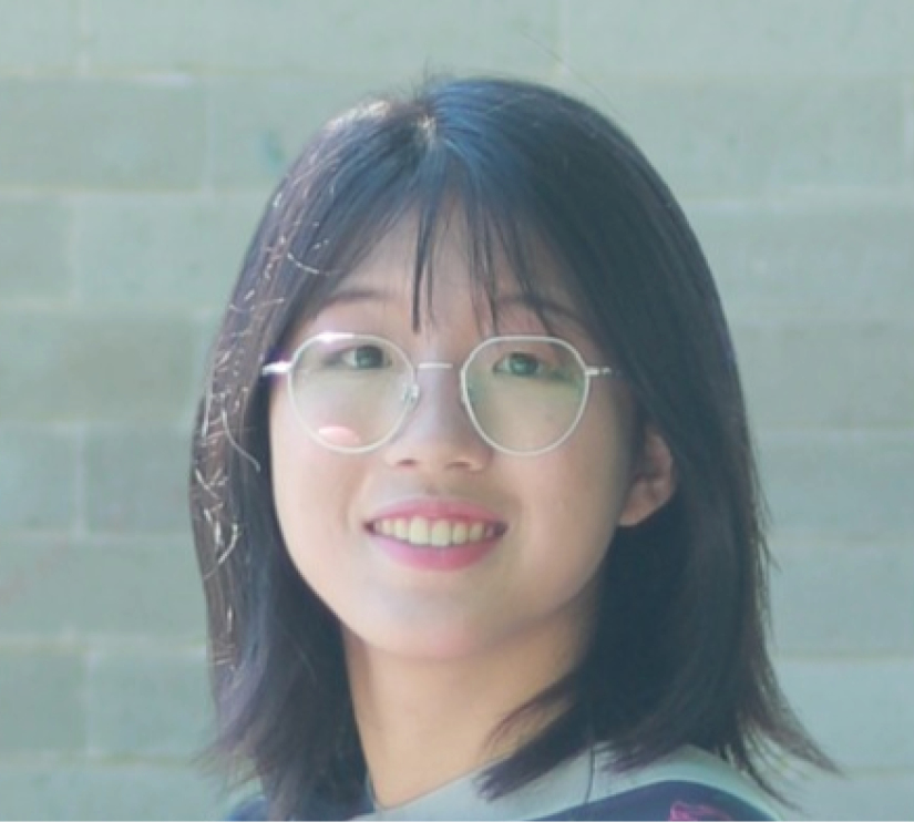 A headshot of PhD math student Hang Chen looking at the camera and smiling. She's wearing silver wire-rimmed glasses and has shoulder-length dark hair.