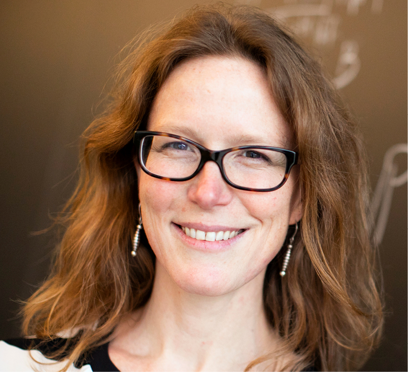 Headshot of Harvard math professor Laura DeMarco smiling at the camera, wearing glasses, with shoulder-length blond hair.