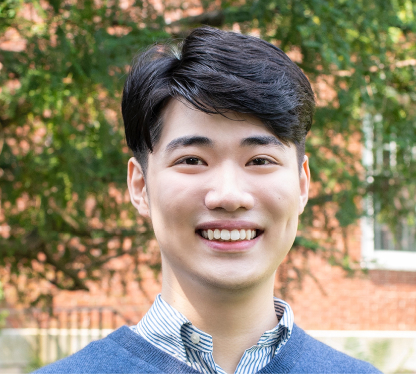 A heads hot of Harvard math preceptor Justin Hancock smiling and looking at the camera.