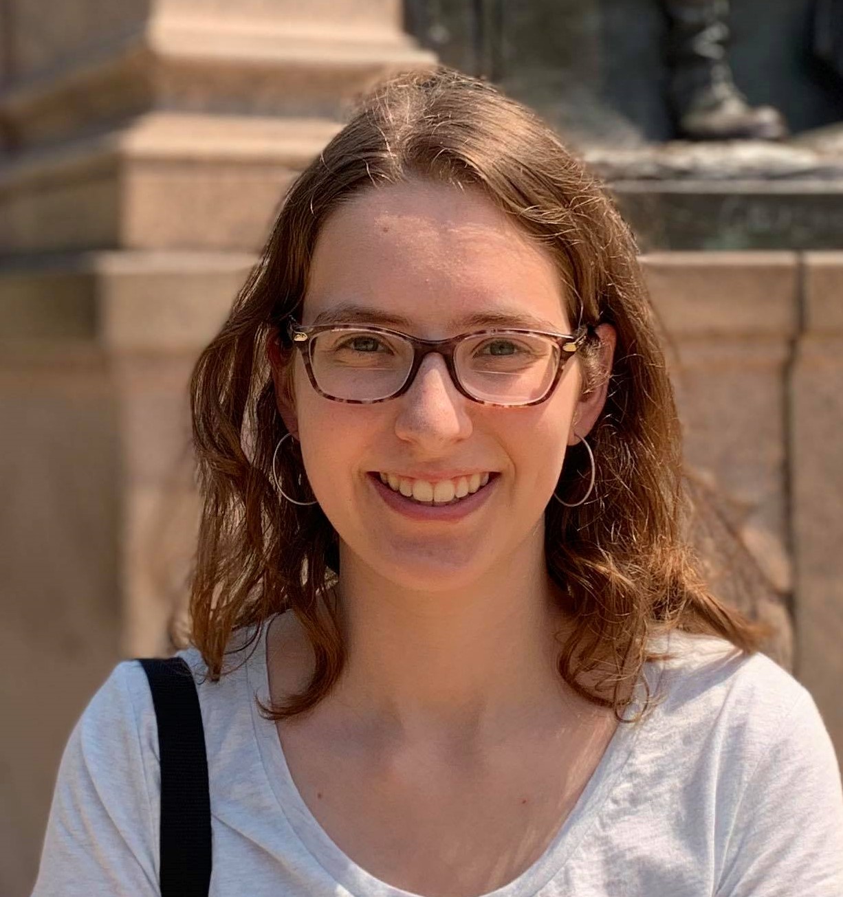A photo from the chest up of Harvard math Ph.D. graduate Naomi Sweeting.